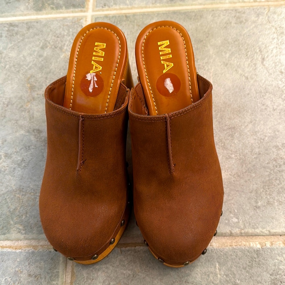 Brown clog heels. Warn once.